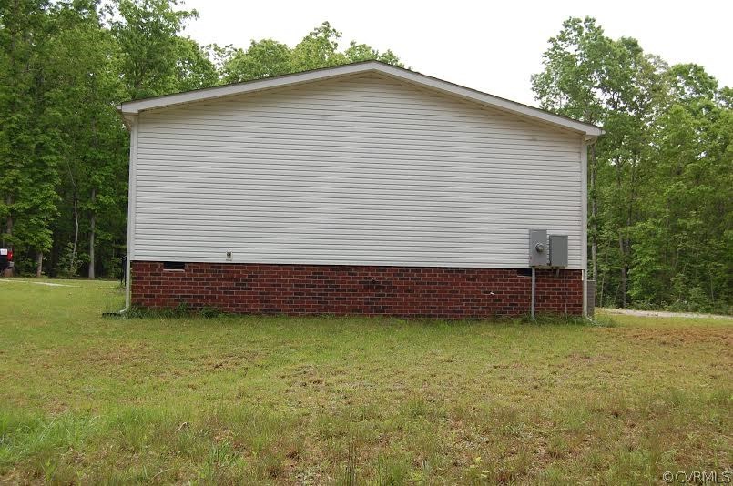 4052 Paynes Mill Road Bumpass, VA 23024 - Photo 16 of 17 a view of a house with a backyard