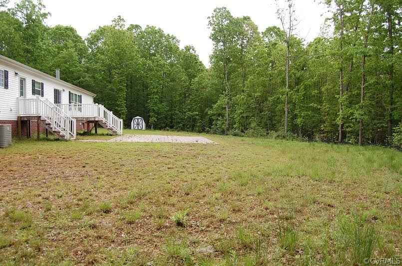 4052 Paynes Mill Road Bumpass, VA 23024 - Photo 3 of 17 a view of a yard with a house