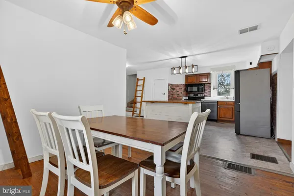 a view of a dining room with furniture and wooden floor