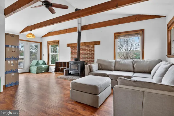 a living room with furniture and wooden floor