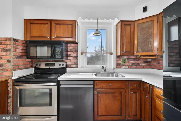 a kitchen with a sink stove and cabinets