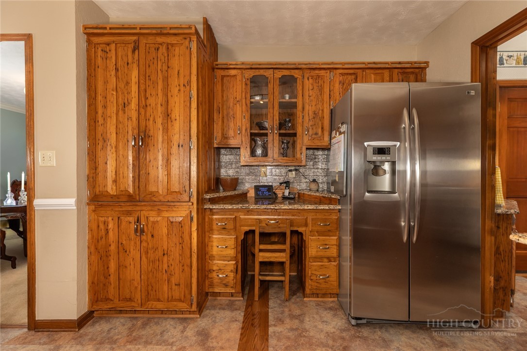 1335 Shingle Gap Road Purlear, NC 28665 - Photo 18 of 49 a kitchen with stainless steel appliances granite countertop a refrigerator and a sink
