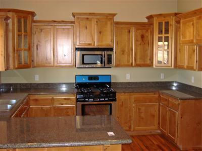 900 Win Way Eagle Point, OR 97524 - Photo 2 of 9 a kitchen with granite countertop a stove a microwave a sink and cabinets
