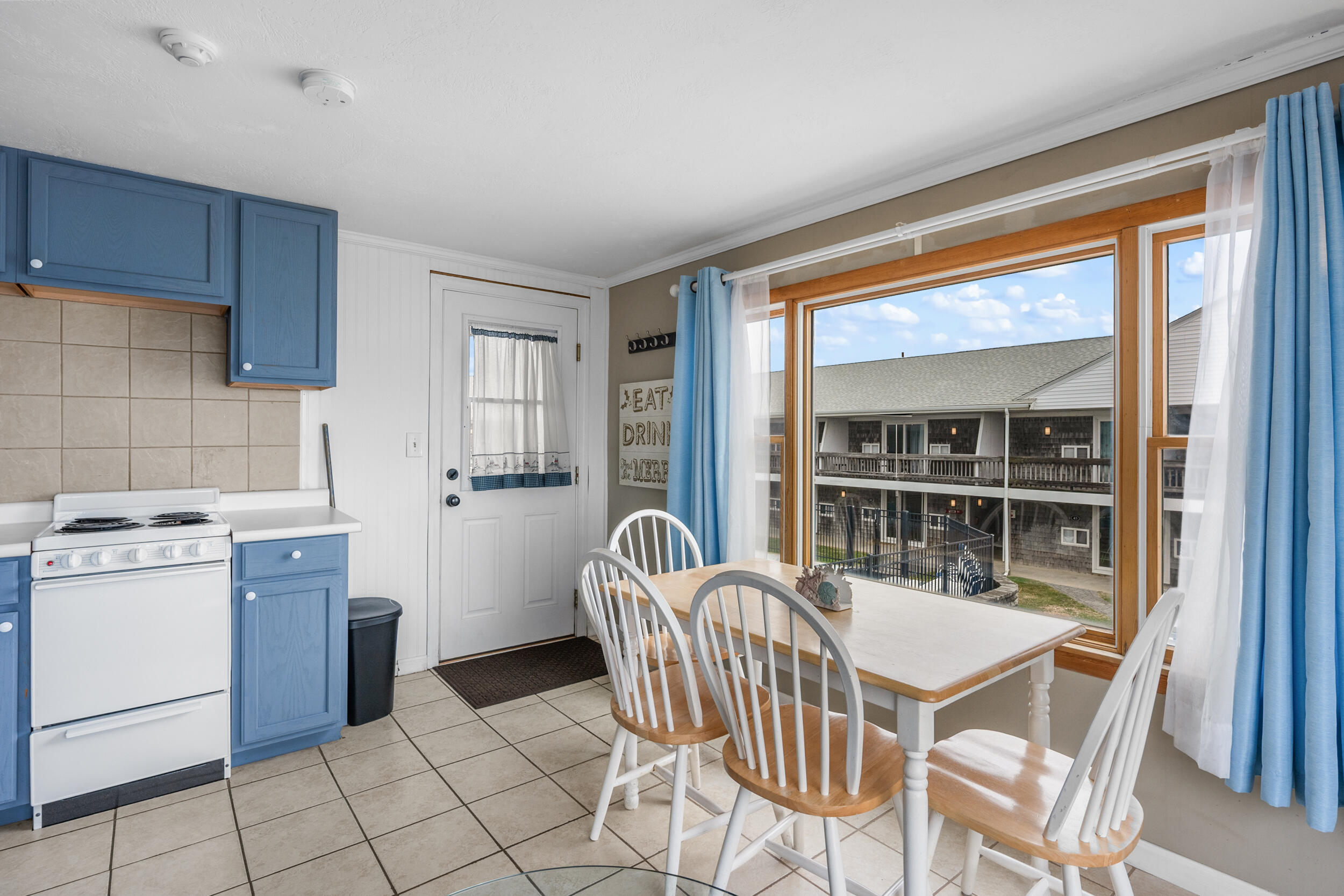 154 Old Wharf Road, Unit U14 Dennis Port, MA 02639 - Photo 16 of 32 a dining room with furniture and large window