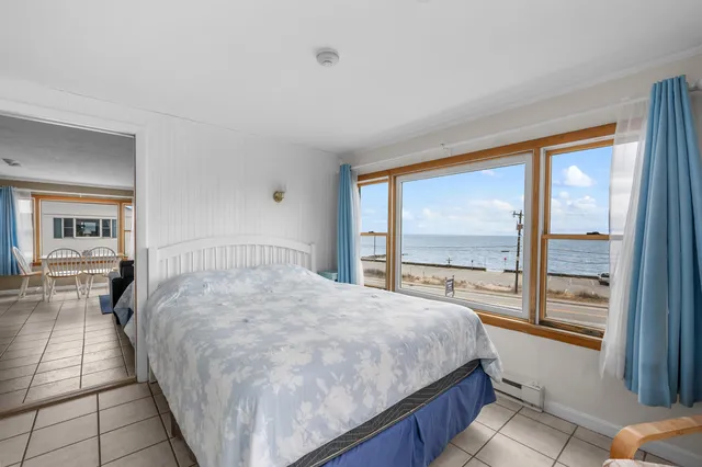 a bedroom with a large bed and a large window