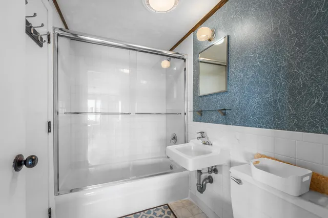 a bathroom with a sink and shower