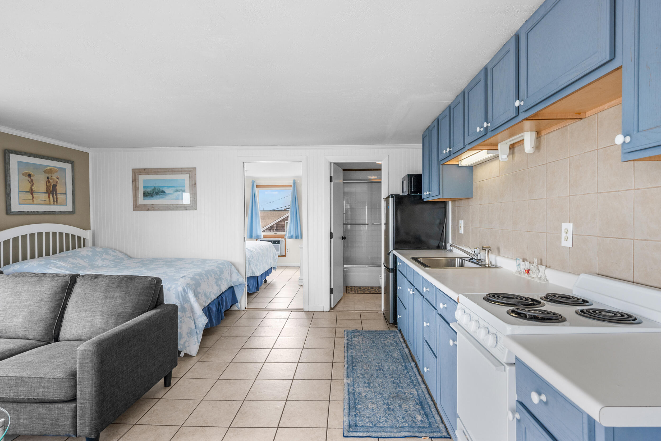 154 Old Wharf Road, Unit U14 Dennis Port, MA 02639 - Photo 8 of 32 a kitchen with stainless steel appliances granite countertop a sink stove and refrigerator