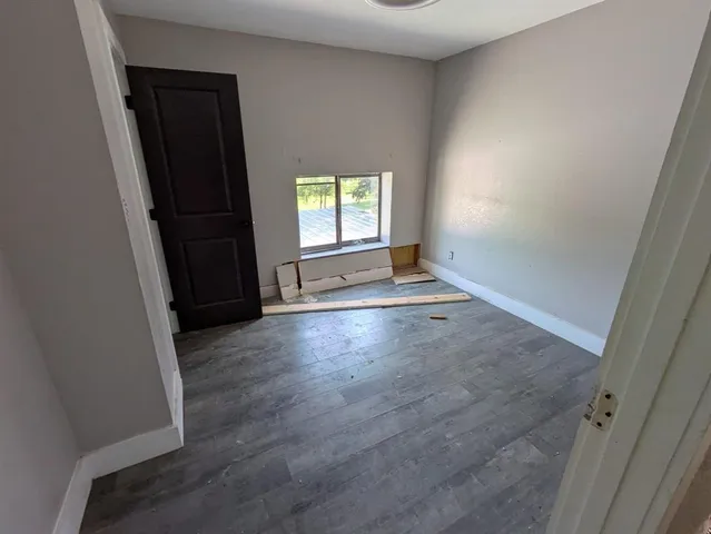 a view of bedroom with wooden floor