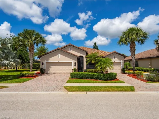 a front view of a house with a yard and a garage