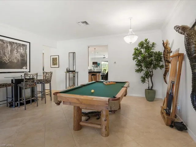 a room with furniture a potted plant and a view of living room