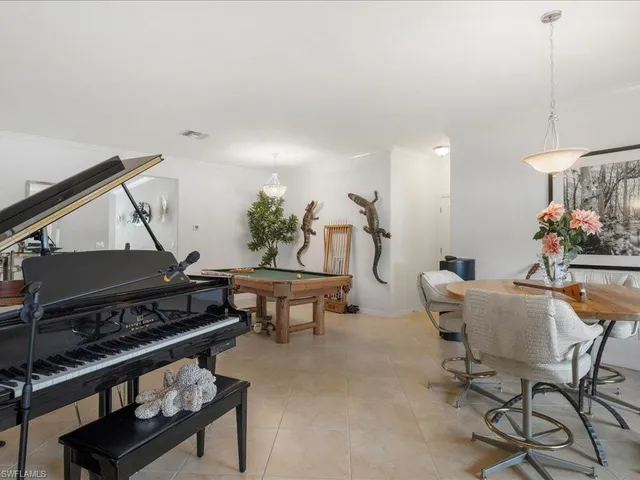 a living room with furniture and a piano