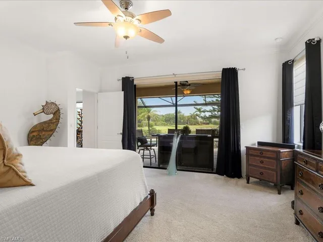 a bedroom with a bed and large window