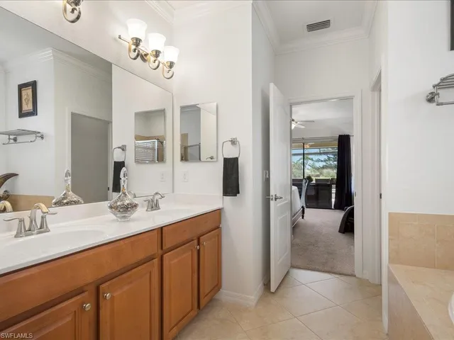a en suite bathroom with a sink double vanity and mirror