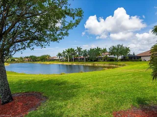 a view of a lake with houses in the back