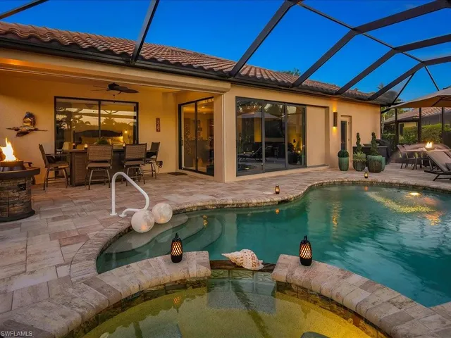 a view of a patio with table and chairs under an umbrella