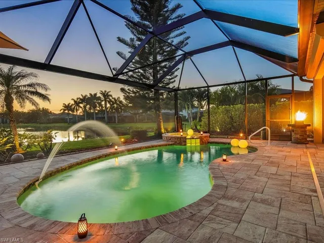 an outdoor space with pool and sitting space