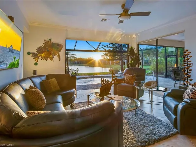 a living room with furniture and a floor to ceiling window