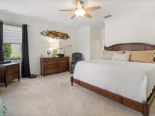 a bedroom with a bed dresser and a window