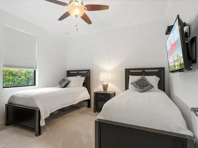 a bedroom with two beds and a painting on the wall