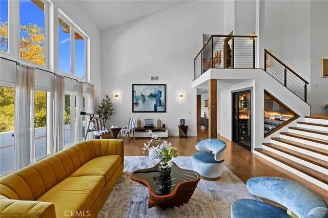 a living room with furniture fireplace and a large window