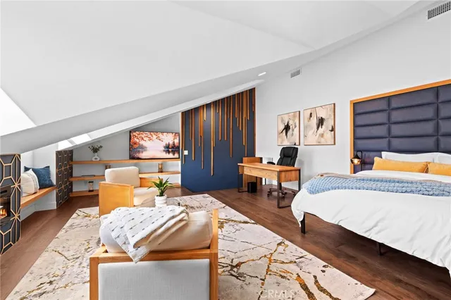 a bedroom with a large bed and a chandelier