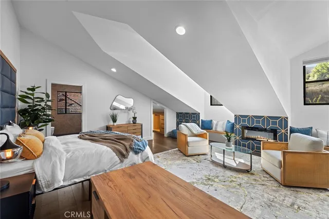 a bedroom with a bed couch and a window