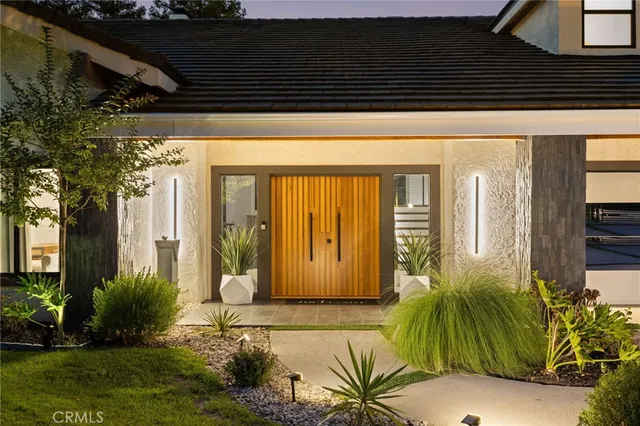 a living room with furniture a large window and wooden floor