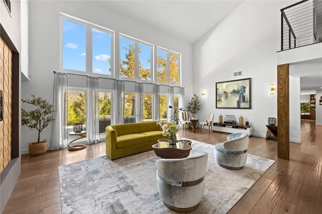 a living room with furniture windows and wooden floor