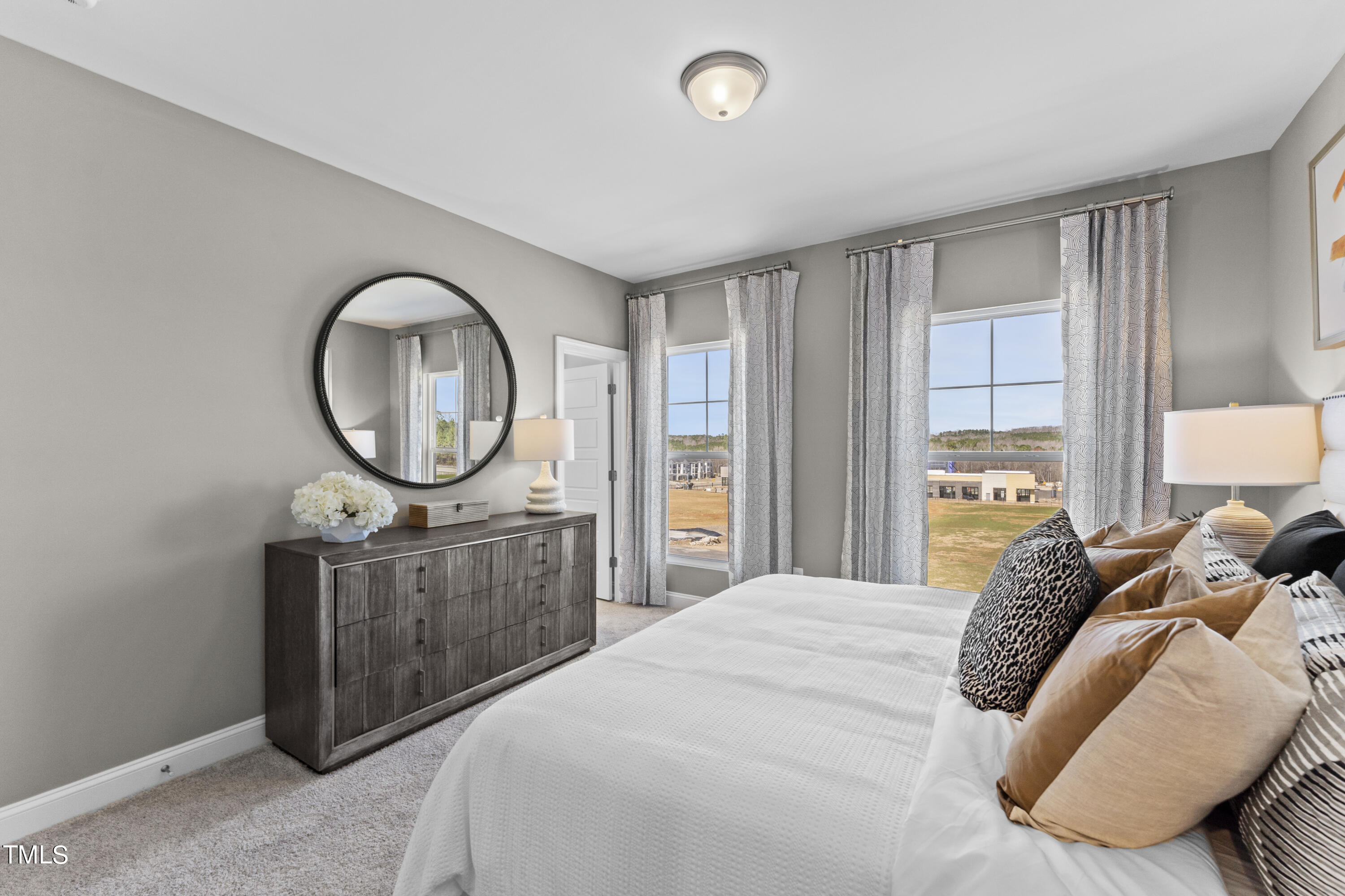 512 Hedrick Ridge Road Cary, NC 27519 - Photo 10 of 19 a bedroom with a bed a mirror on dresser and a window
