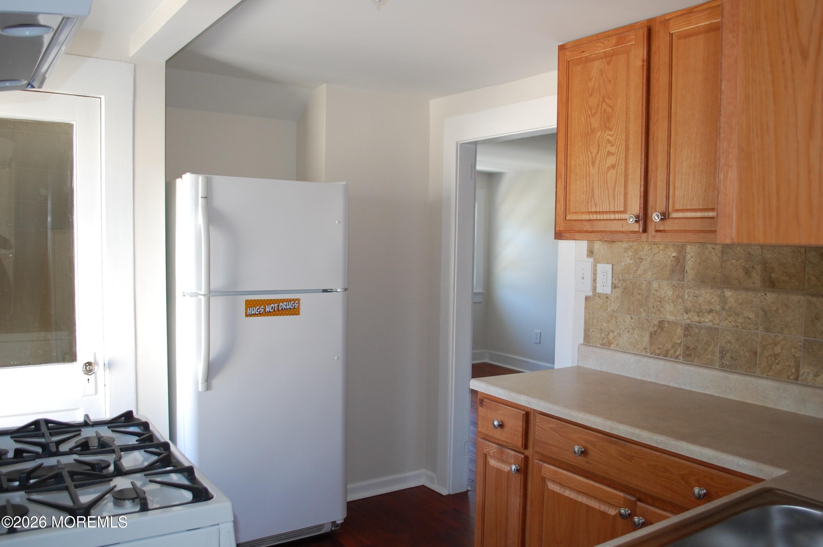 107 Broad Street, Unit B Matawan, NJ 07747 - Photo 4 of 10 a view of a kitchen with refrigerator and stove