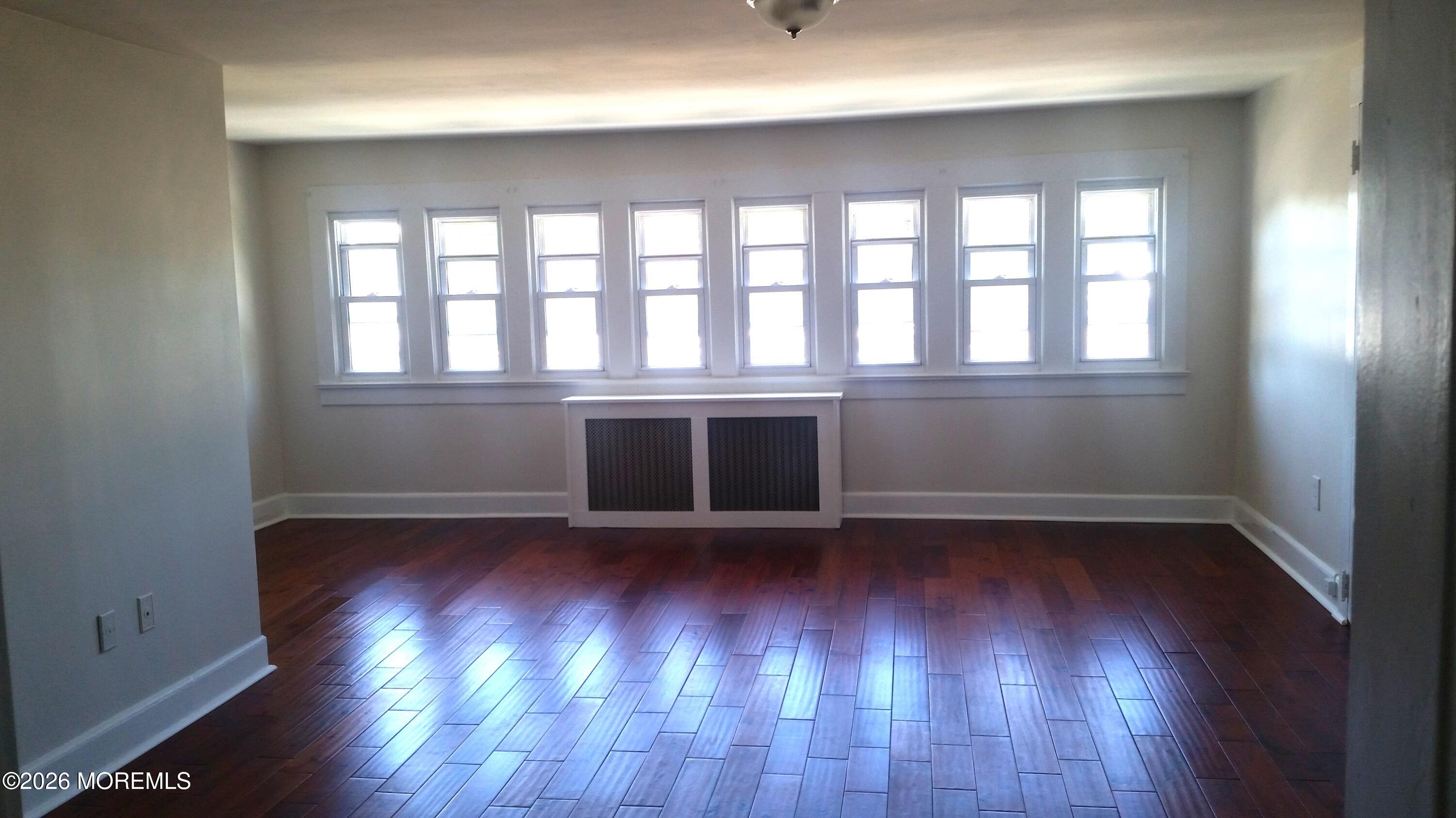 107 Broad Street, Unit B Matawan, NJ 07747 - Photo 6 of 10 wooden floor in an empty room with a window