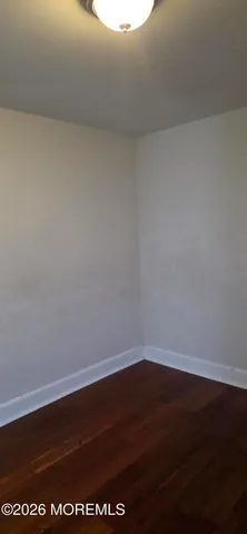 a view of room with wooden floor