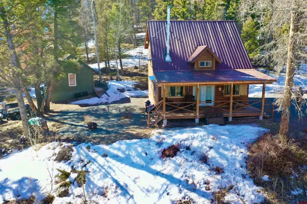 a view of a chairs and table in backyard