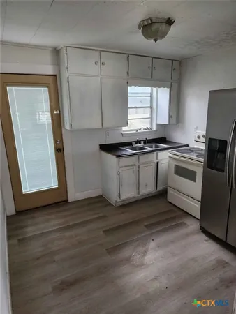 a bathroom with a toilet sink and shower