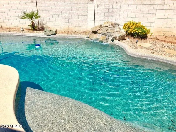 a view of a swimming pool with a lounge chairs