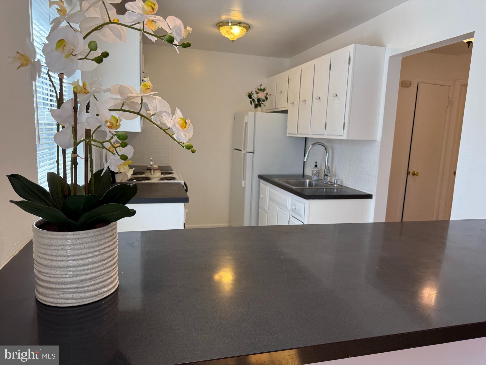 121 The Orchards, Unit I Cranbury, NJ 08512 - Photo 12 of 26 a kitchen with a sink and cabinets