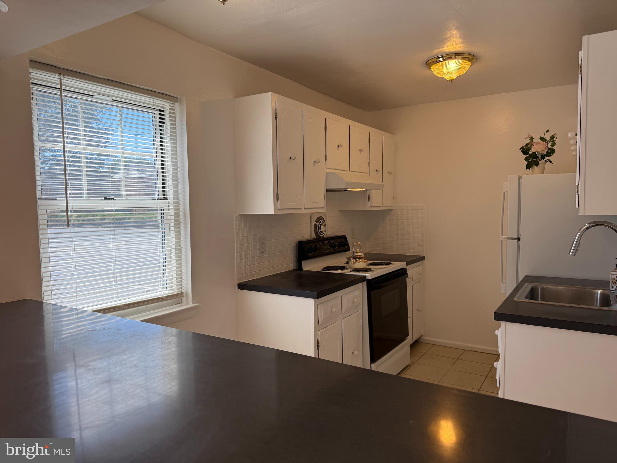 121 The Orchards, Unit I Cranbury, NJ 08512 - Photo 13 of 26 a kitchen with granite countertop a stove and a sink