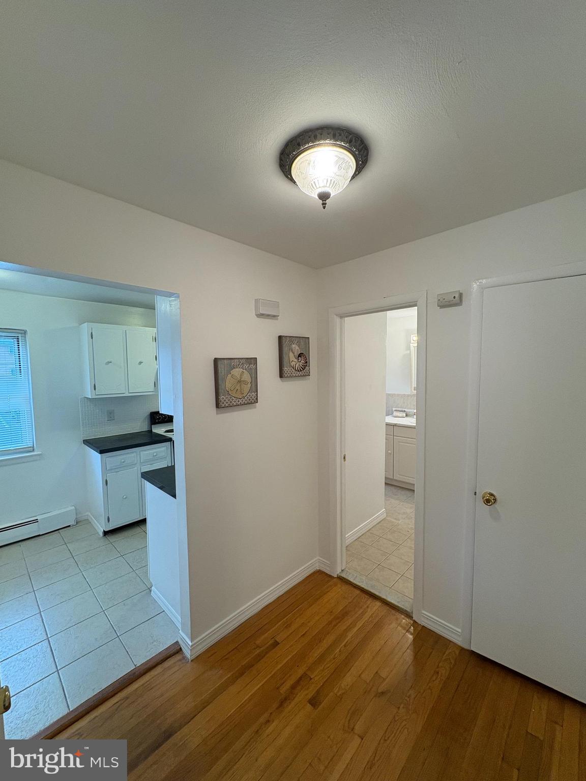 121 The Orchards, Unit I Cranbury, NJ 08512 - Photo 16 of 26 a view of a room with wooden floor and white walls