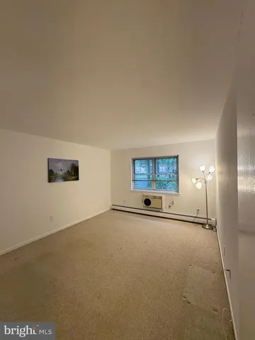 an empty room with staircase and windows