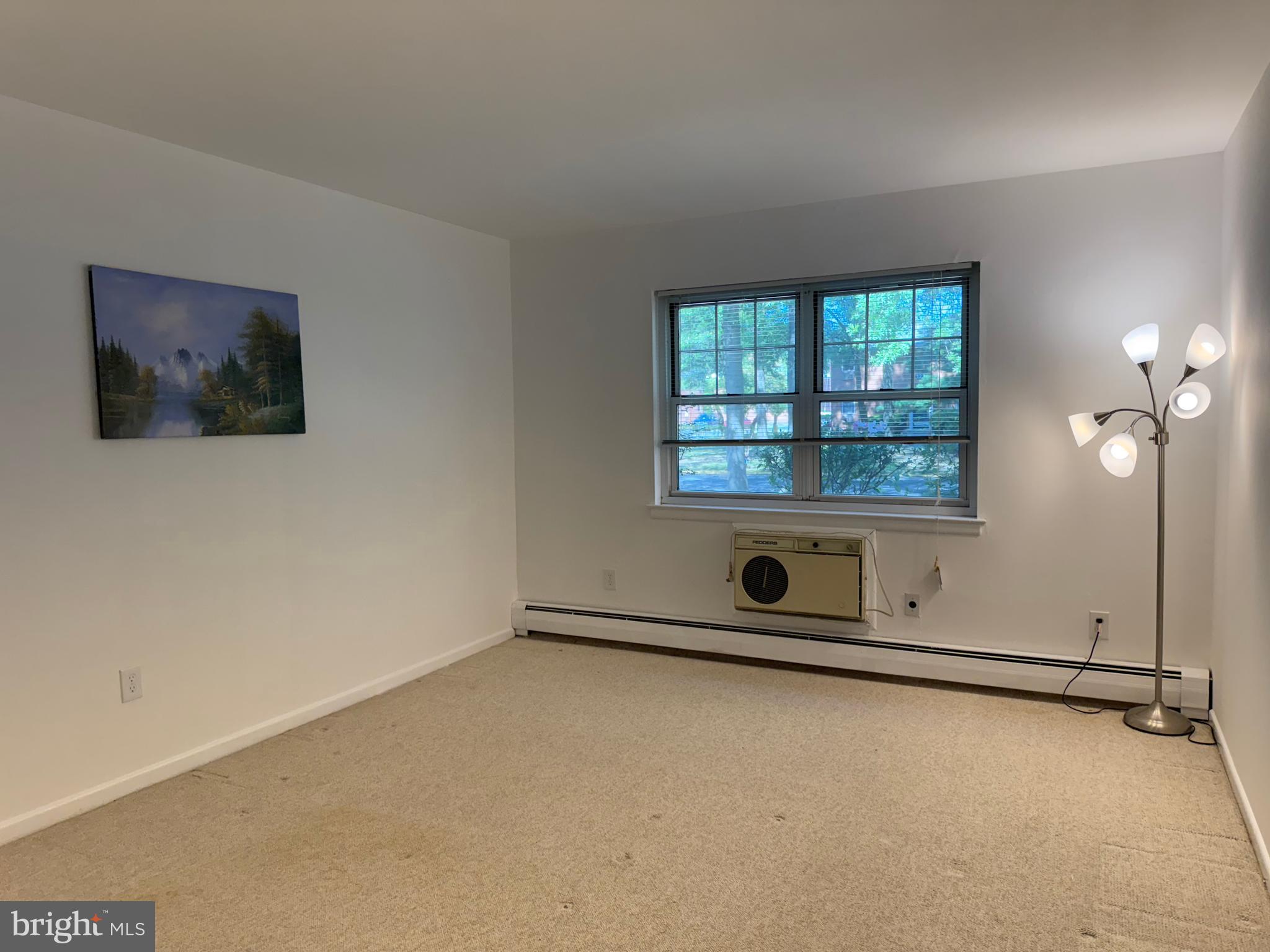 121 The Orchards, Unit I Cranbury, NJ 08512 - Photo 18 of 26 an empty room with windows