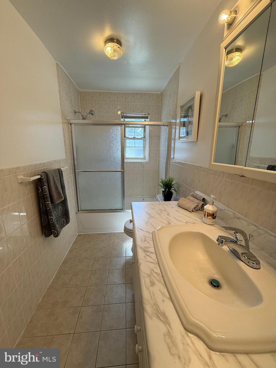 121 The Orchards, Unit I Cranbury, NJ 08512 - Photo 21 of 26 a bathroom with a sink and mirror