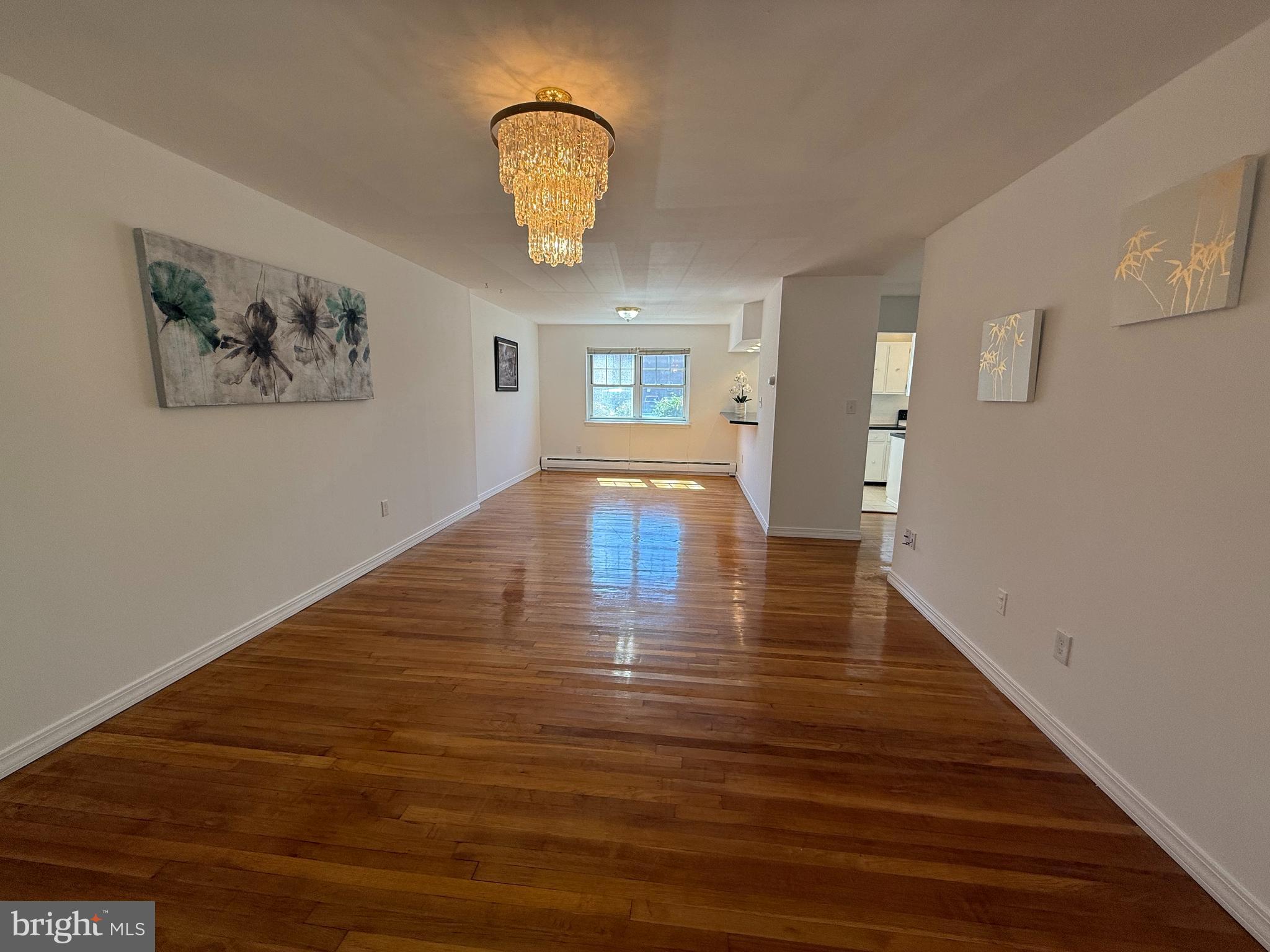 121 The Orchards, Unit I Cranbury, NJ 08512 - Photo 6 of 26 a view of empty room with wooden floor