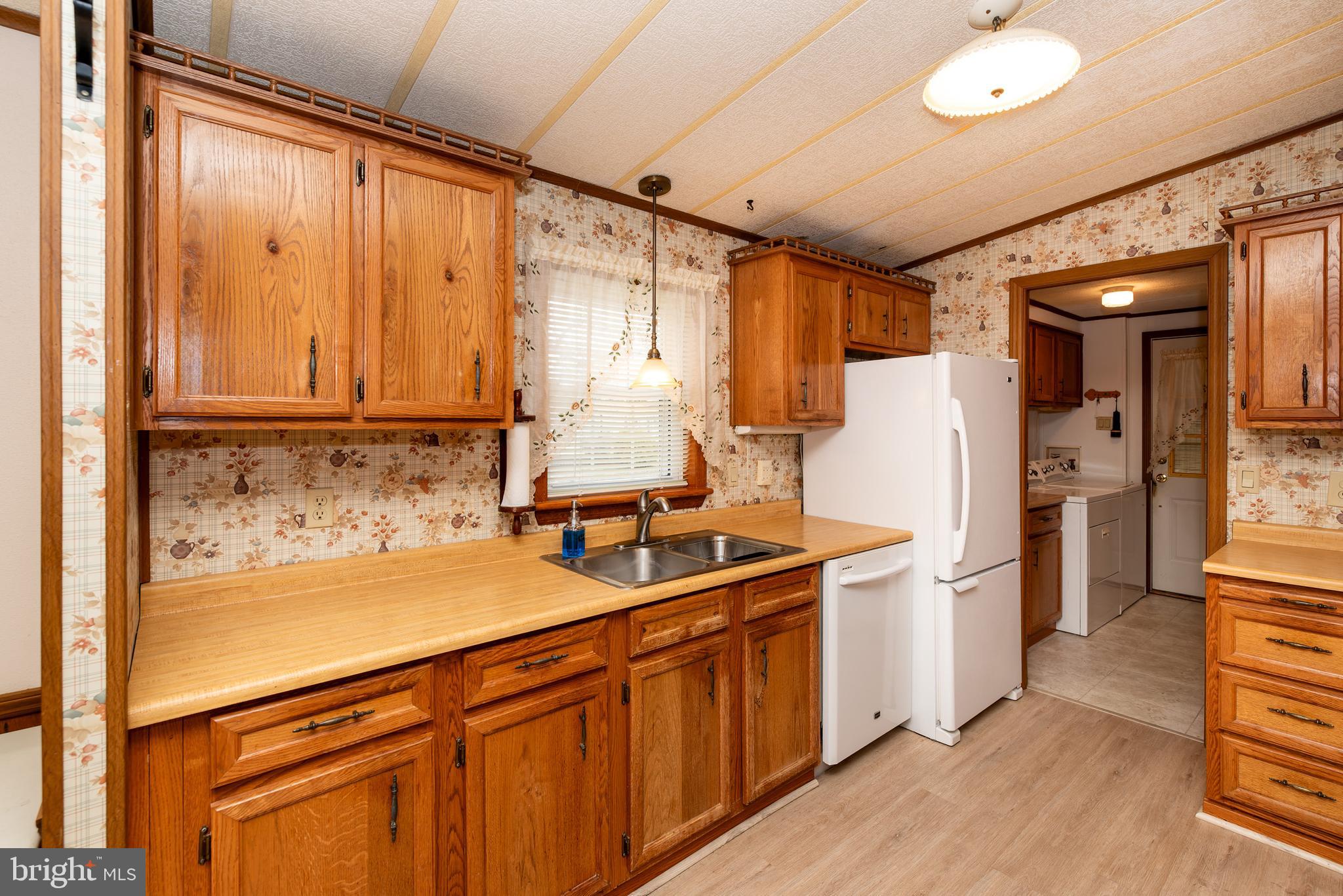 453 Priscilla Lane Buena, NJ 08310 - Photo 12 of 52 a kitchen with a sink and a refrigerator