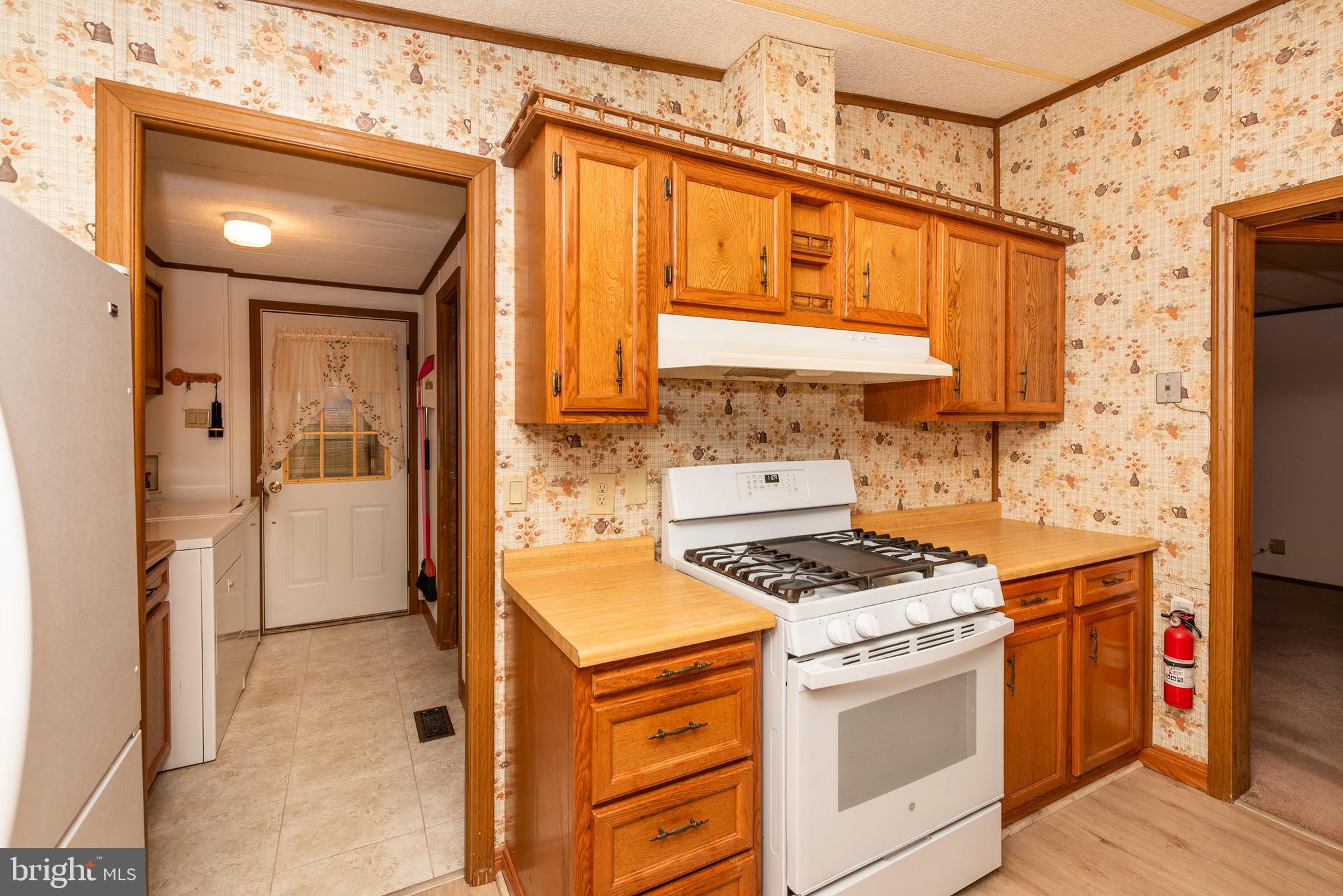 453 Priscilla Lane Buena, NJ 08310 - Photo 13 of 52 a kitchen with stainless steel appliances a stove a sink and a refrigerator