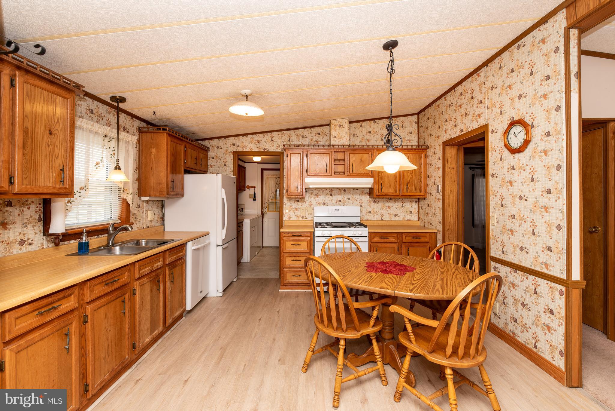 453 Priscilla Lane Buena, NJ 08310 - Photo 10 of 52 a kitchen with stainless steel appliances granite countertop a sink and a refrigerator