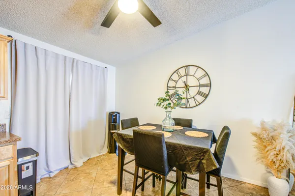 a view of a dining room with furniture and a window