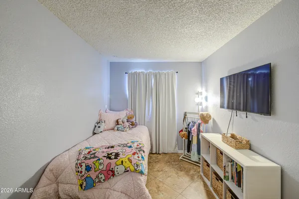 a bedroom with two beds and a window