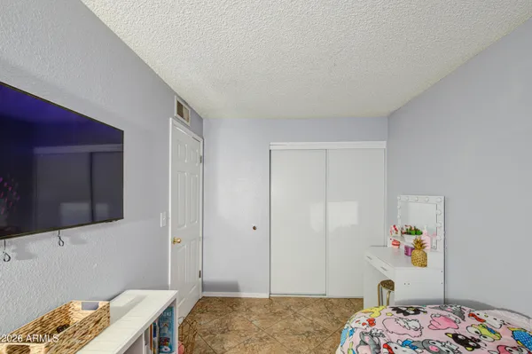 a bedroom with a bed and a dresser in it