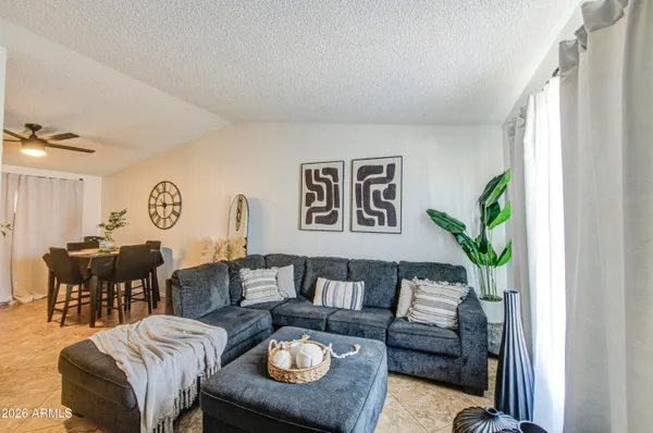 a living room with furniture and a chandelier
