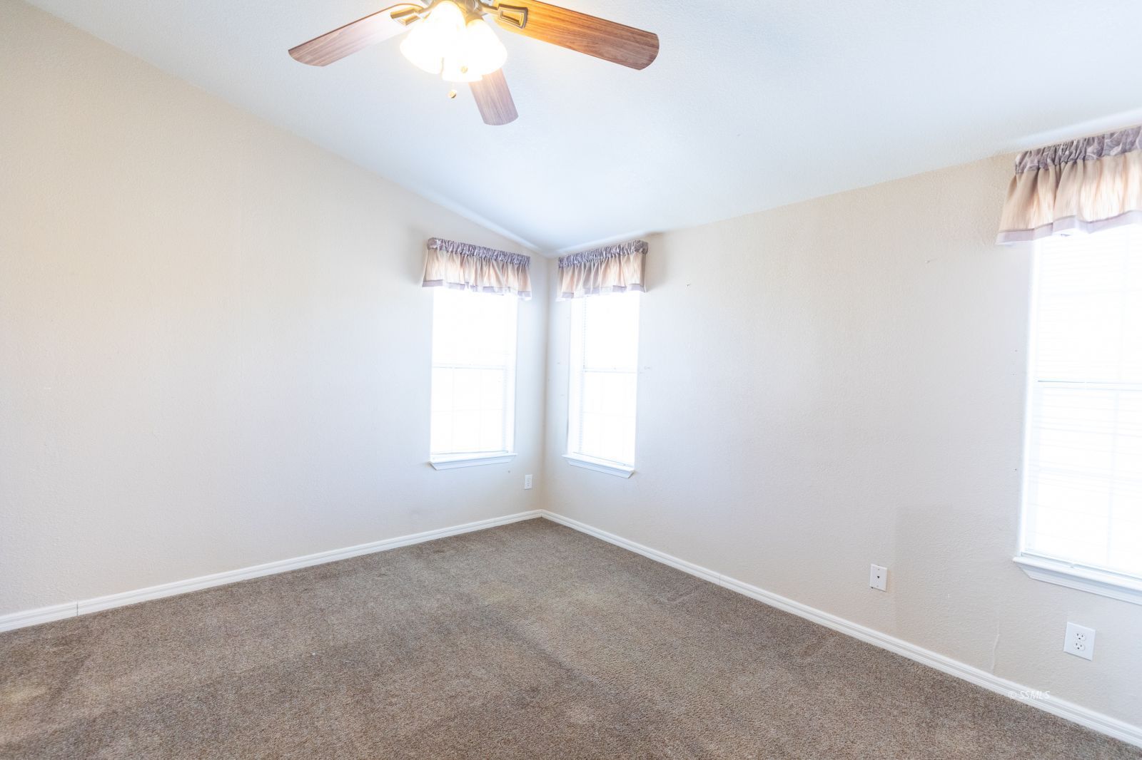 957 East Springer Avenue Ridgecrest, CA 93555 - Photo 18 of 31 an empty room with windows and chandelier fan